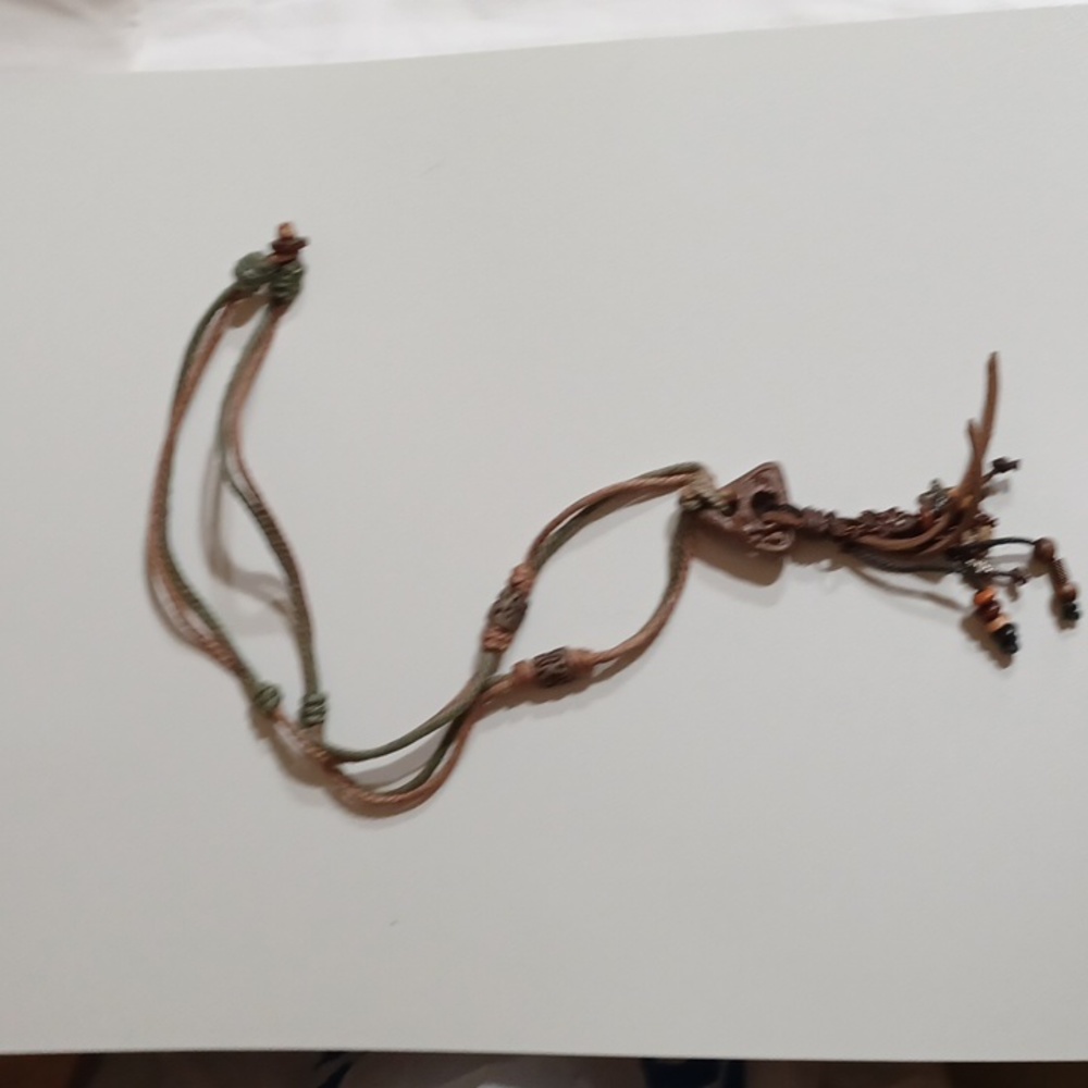 Tribal design necklace with artisan brown rope and leather. 17" L. Brown